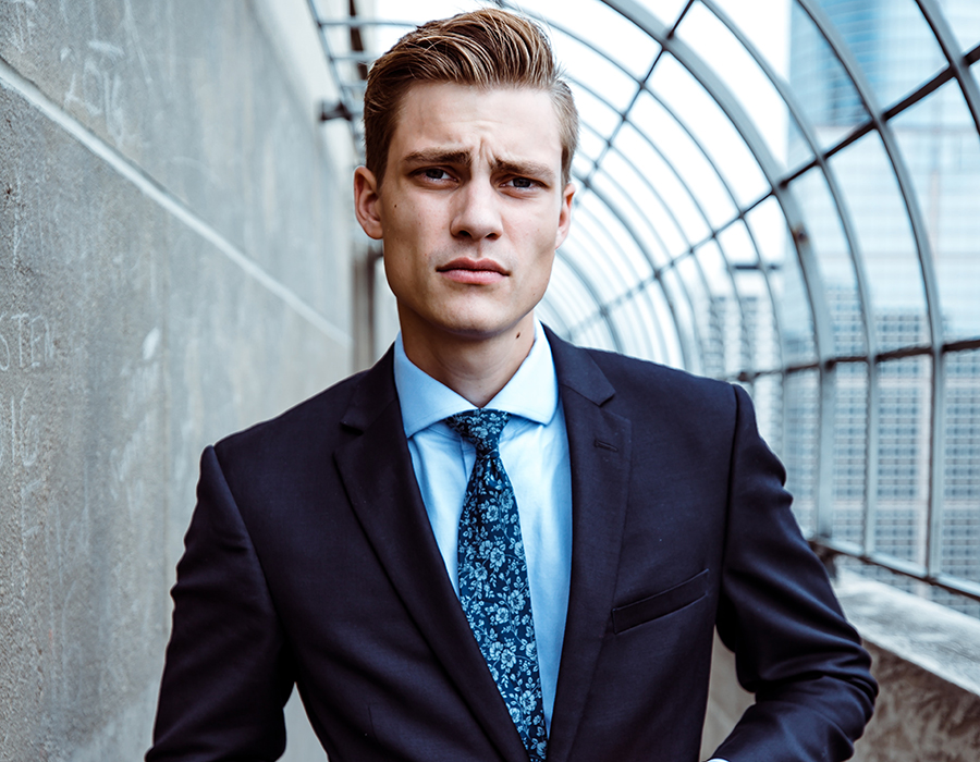 Man in classy suit with blonde pompadour